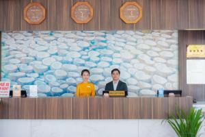 two people sitting at a counter in a room at Ben Tre Riverside Resort in Ben Tre