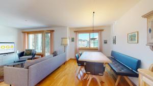 un soggiorno con divani e tavolo in legno di Abitaziun Ova Cotschna 3B - St Moritz a Sankt Moritz