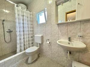 a bathroom with a toilet and a sink at Apartmani Selina in Jadranovo +78 photos
