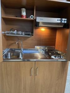 a kitchen with a sink and a stove at CALIDARIUM in Brindisi