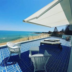 a patio with a table and chairs and the beach at B&B Mammaliturchi SCALA DEI TURCHI in Realmonte