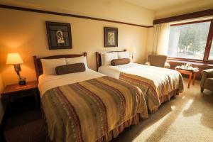 a hotel room with two beds and a window at Alyeska Resort in Girdwood