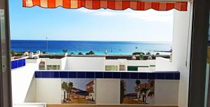 a view of the beach from a window of a building at AZAHARA PLAYA LAS VISTAS - STUDIO - Playa de Las Americas in Playa de las Americas