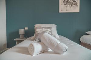 a bedroom with a bed with towels on it at HOTEL DU MOULIN in Voué