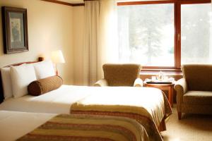 a hotel room with two beds and a window at Alyeska Resort in Girdwood