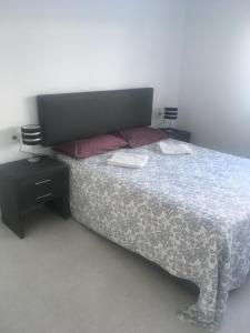 a bedroom with a bed and two night stands at Casa Escocesa in San Pedro del Pinatar