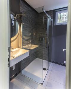 a bathroom with a glass shower and a sink at Apartment Nevena in Belgrade