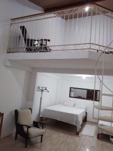 a white room with a bed and a loft at Centric Alter a 600m da praia in Alter do Chao