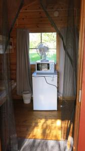 a kitchen with a microwave on top of a refrigerator at Marjoniemi Camping in Hiidenniemi +119 photos