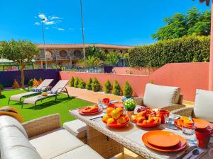 a table with fruit on it on a patio at Lemon Terraced House in Playa del Ingles