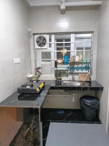 a kitchen with a sink and a counter top at Alyaleesya Emerald avenue 4 Brinchang for muslim in Brinchang