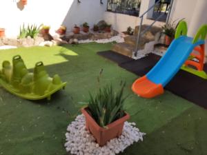 a backyard with a playground with a slide and a plant at CASA RURAL "ECCEHOMO de BORJA" in Borja