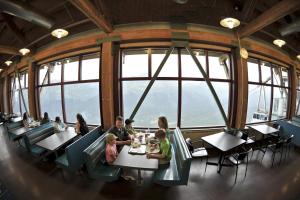 a group of people sitting at tables in a restaurant at Alyeska Resort in Girdwood