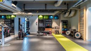a garage with a gym with a yellow stripe on the floor at Hotel Mona Plaza in Belgrade