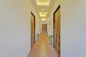 a hallway with wooden doors and potted plants at OYO Townhouse 1090 G SILVER HOTELS NEAR US BIOMETRIC in Chennai