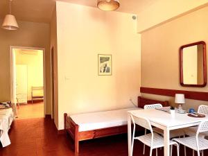a room with a bed and a table and chairs at Fedra Apartments in Poros +55 photos