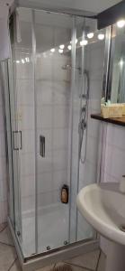 a shower with a glass door next to a sink at Casa Graziella in Brindisi