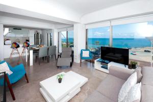 a living room with a view of the ocean at Apartment Marisol - Beachfront in Protaras