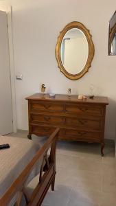 a bedroom with a dresser with a mirror on the wall at Casa Vacanze Trebiano in Trebiano