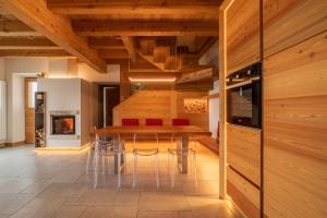 a dining room with wooden walls and a table and chairs at Casera Degnona in Chies dʼAlpago
