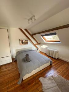 ein Schlafzimmer mit einem großen Bett im Dachgeschoss in der Unterkunft Le relais des trois châteaux in Flixecourt