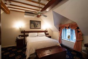 een slaapkamer met een groot bed en een raam bij Santo's Higham Farm Hotel in Alfreton