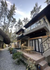 Casa con porche de madera y patio. en Liwa-Liw Beach Villas & Dome Glamping, en San Felipe
