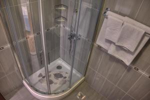 a shower with a glass door in a bathroom at Guesthouse Victoria II in Dubrovnik