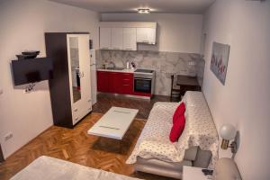 a small kitchen with a couch and a table in a room at Guesthouse Victoria II in Dubrovnik