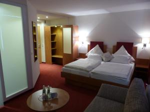 
a hotel room with two beds and a television at City Hotel by celina in Hagen
