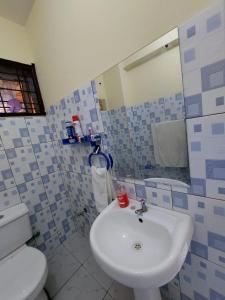 a bathroom with a white sink and a toilet at Roma Stays - Spacious Studio in Nyali opp Retna Square Close to Nyali Cinemax in Kisauni