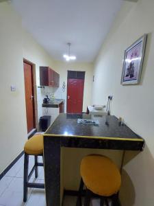 a kitchen with a counter and two stools in a room at Roma Stays - Spacious Studio in Nyali opp Retna Square Close to Nyali Cinemax in Kisauni