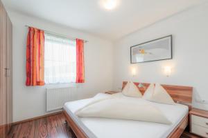 Posteľ alebo postele v izbe v ubytovaní Alpenjuwel Appartements
