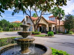 a fountain in front of a house at Disney Memories at Tuscana Resort in Kissimmee