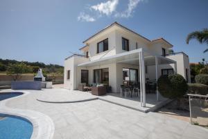 a villa with a swimming pool and a house at Villa Margarita in Protaras