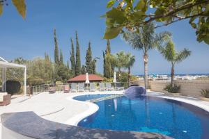 a swimming pool in a resort with a gazebo at Villa Margarita in Protaras