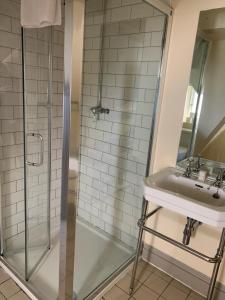 a bathroom with a shower and a sink at Thornton Manor - Holiday Cottages and Apartments in Heswall