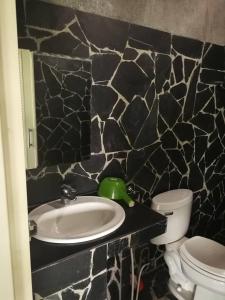 a bathroom with a sink and a toilet at Starry Night hostel in Ban Mae Chong