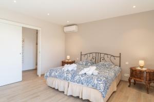 a bedroom with a bed with two pillows on it at Le Mas de l'Olivier in Plan-dʼOrgon +22 photos