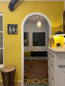 a living room with yellow walls and a couch at Kasbah’s road Art house in Tangier +38 photos