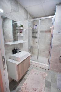 a bathroom with a white sink and a shower at King Suite AE8 in Esenyurt