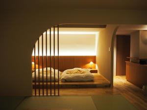 a bedroom with a bed with a gate around it at Negiya Ryofukaku in Kobe +60 photos