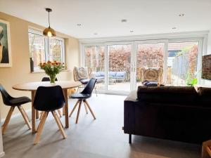 a living room with a couch and a table and chairs at Vakantiehuis Aagtekerke AK12 in Aagtekerke