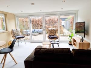 a living room with a couch and chairs at Vakantiehuis Aagtekerke AK12 in Aagtekerke