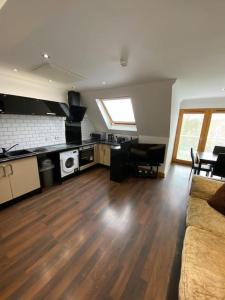 a living room with a couch and a kitchen at spacious 2 bed apartment in Norwich city centre in Norwich