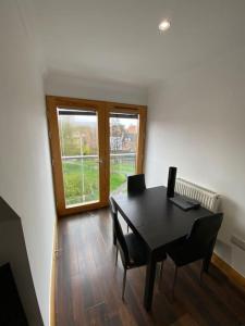a dining room with a table and chairs and a window at spacious 2 bed apartment in Norwich city centre in Norwich