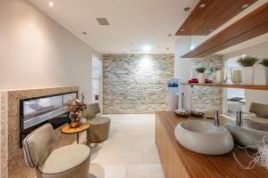 a living room with a sink and a fireplace at Feel Good Apartments in Krumpendorf am Wörthersee