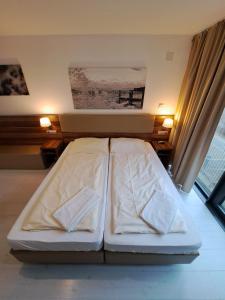uma cama num quarto com duas almofadas em Jezza Apart Suite em Munique
