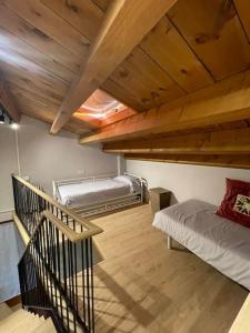 a room with two bunk beds and a staircase at Casa Rural Can Titus in L’ Esquirol