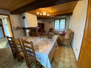 a kitchen and dining room with a table and chairs at Le Val Godard in Fresnay-le-Samson